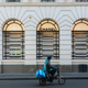 File photo of a food delivery rider driving past a Chanel store on October 26, 2020 in Melbourne, Australia.
